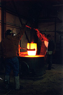 Removing Crucible of Molten Bronze from Furnace