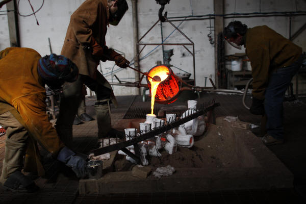 Pouring Bronze into Shell Mold