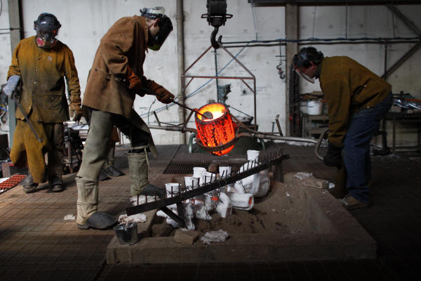 Pouring Bronze into Shell Mold