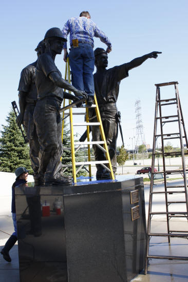 Scrubbing "Teamwork" Sculpture